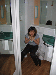 Miaomiao on the toilet in our bathroom in a hotel in the city center
