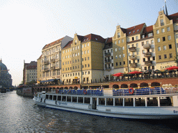 Boat in the Spree river, houses at the Spreeufer street and the Berlin Cathedral, viewed from the tour boat