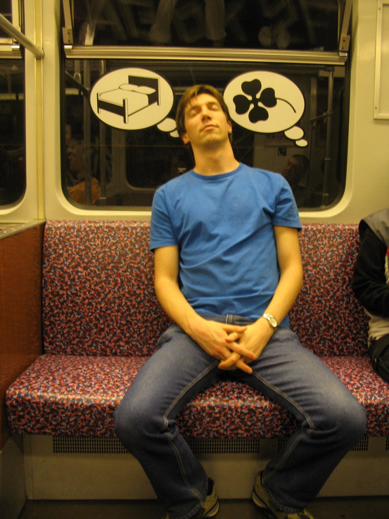 Tim sleeping in a subway train