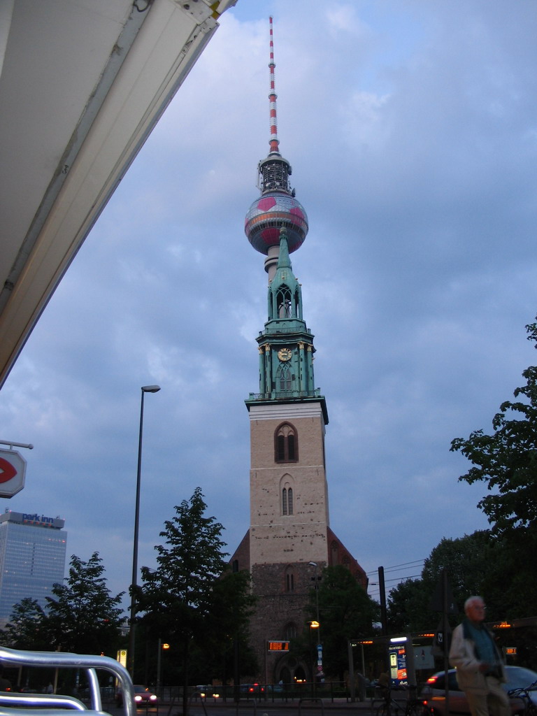 St. Mary`s Church and the Fernsehturm tower, viewed from the Karl-Liebknecht Straße street, at sunset