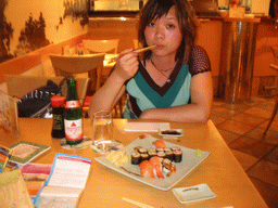 Miaomiao eating sushi in a restaurant in the city center