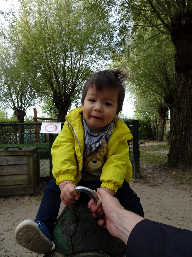 Max on a spring rocker at the playground at BestZoo