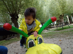 Max on a spring rocker at the playground at BestZoo