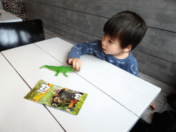 Max with a crocodile toy at the restaurant at BestZoo