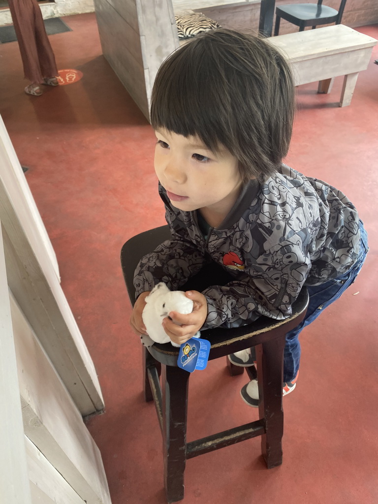 Max with a Snowy Owl toy at the restaurant at BestZoo