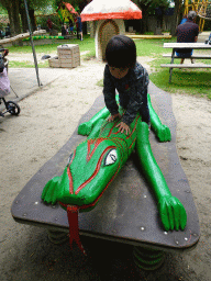 Max on a lizard statue at the playground at BestZoo