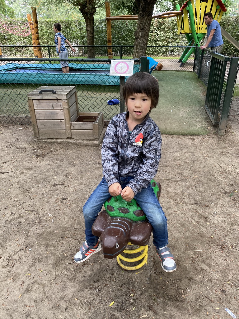 Max on a spring rocker at the playground at BestZoo