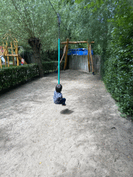 Max on a zip line at the playground at BestZoo