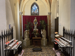 Statues and candles at the northwest chapel of the Sint-Odulphuskerk church