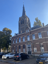 Front of the Sint Odulphus Pastorie building and the north side of the Sint-Odulphuskerk church at the Hoofdstraat street