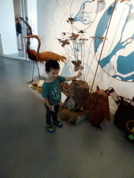 Max with animal statues in the lobby of the Biesbosch MuseumEiland