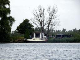 Boat on the Gat van den Kleinen Hil lake and a house, viewed from the Fluistertocht tour boat