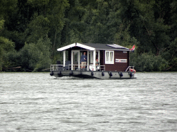 Log cabin boat at the Kooigat lake, viewed from the Fluistertocht tour boat