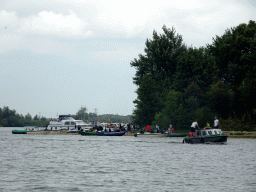 Boats at the Rietplaat island, viewed from the Fluistertocht tour boat on the Gat van van Kampen lake