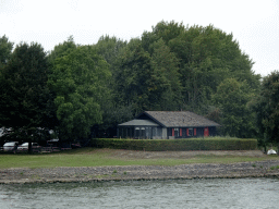 Building at the Kop van `t Land side, viewed from the Biesbosch Ferry over the Nieuwe Merwede canal