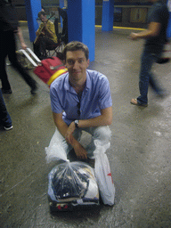Tim with laundry in the subway station
