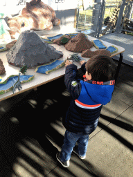 Max playing with dinosaur toys at the Middle Floor of the Dinohal building of the Oertijdmuseum