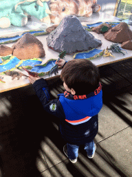 Max playing with dinosaur toys at the Middle Floor of the Dinohal building of the Oertijdmuseum