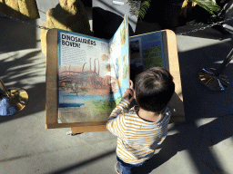 Max with a Dinosaur book at the Lower Floor of the Dinohal building of the Oertijdmuseum