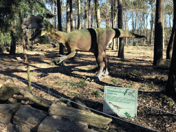 Statue of a Dilophosaurus in the Oertijdwoud forest of the Oertijdmuseum, with explanation