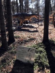 Statues of a Stegosaurus and an Allosaurus in the Oertijdwoud forest of the Oertijdmuseum, with explanation
