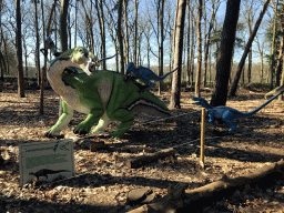 Statue of a Tenontosaurus being attacked by Deinonychuses in the Oertijdwoud forest of the Oertijdmuseum, with explanation