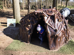 Max and a prehistoric hut in the Oertijdwoud forest of the Oertijdmuseum, with explanation