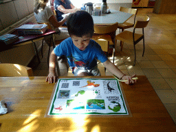 Max doing a puzzle at the restaurant at the Lower Floor of the Museum building of the Oertijdmuseum