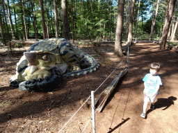 Max with a statue of a dinosaur at the Oertijdwoud forest of the Oertijdmuseum