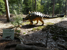 Statue of an Euoplocephalus at the Oertijdwoud forest of the Oertijdmuseum, with explanation