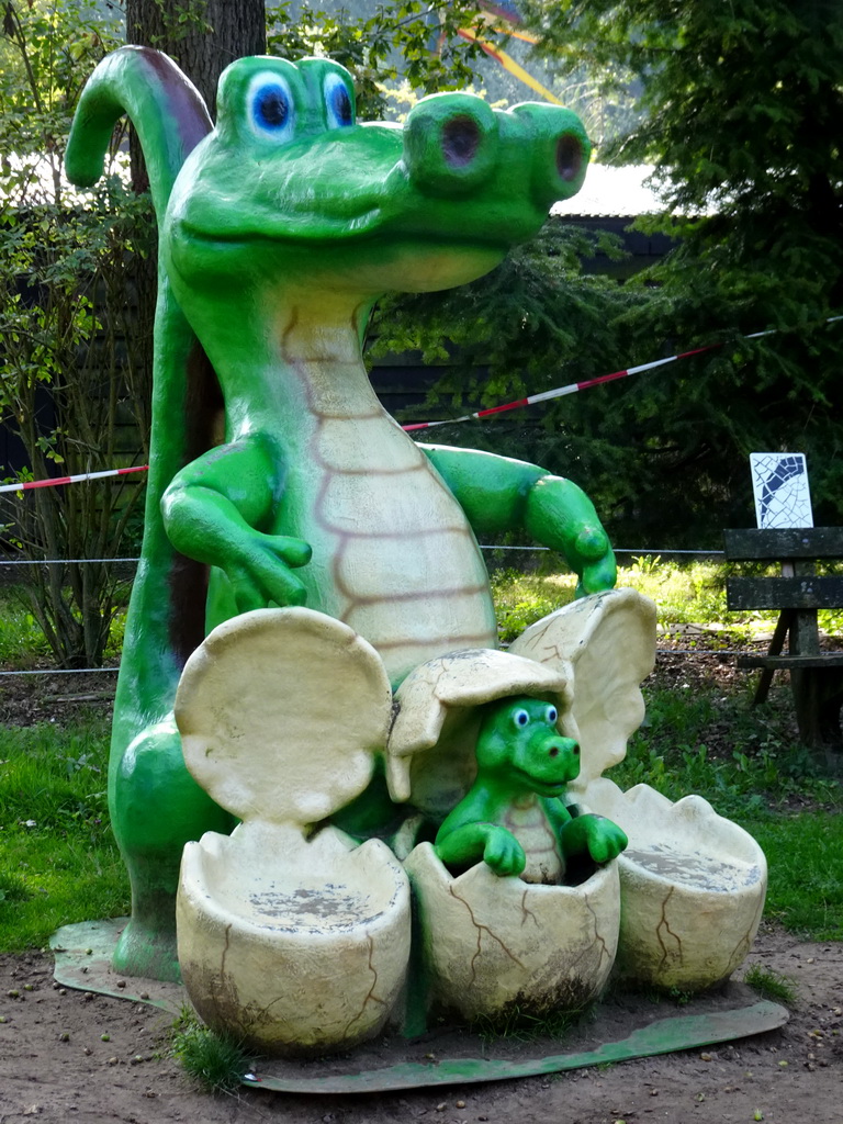 Statue of a Crocodile with eggs at the playground in the Oertijdwoud forest of the Oertijdmuseum