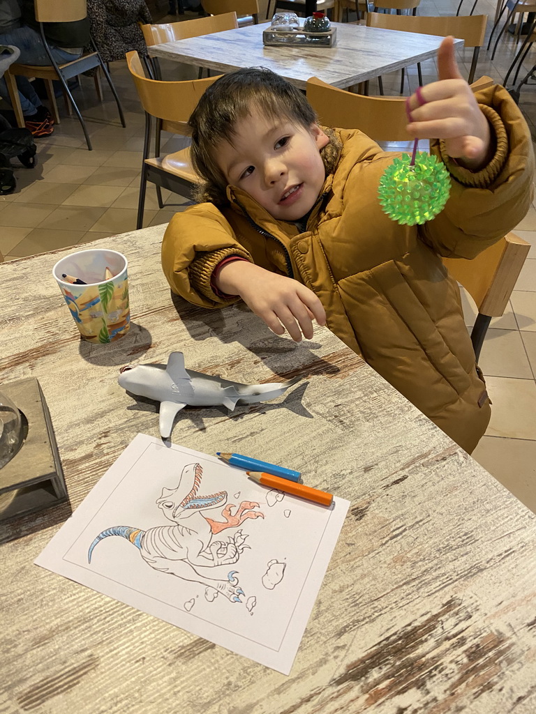 Max with a coloring page and toys at the restaurant at the Lower Floor of the Museum building of the Oertijdmuseum