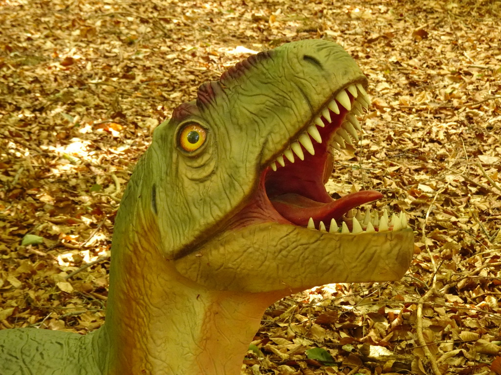 Head of a dinosaur statue in the Oertijdwoud forest of the Oertijdmuseum