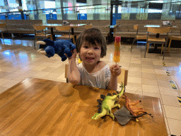 Max with dinosaur toys and an ice cream at the restaurant at the Lower Floor of the Museum Building of the Oertijdmuseum