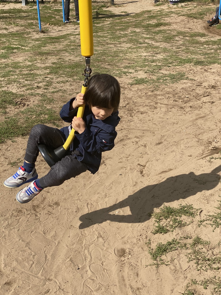 Max on a swing at the playground at the Garden of the Oertijdmuseum