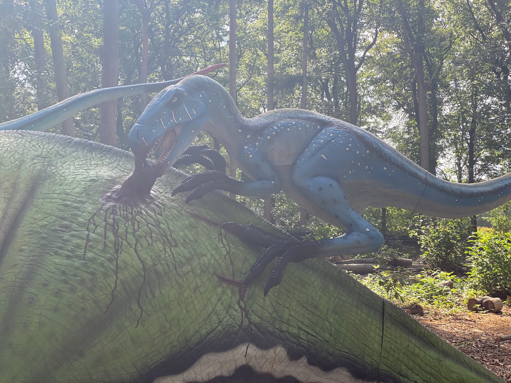 Statue of a Deinonychus attacking a Tenontosaurus in the Oertijdwoud forest of the Oertijdmuseum
