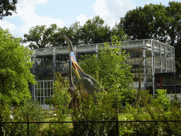 Diplodocus and Quetzalcoatlus statues in front of the Dinohal building at the Garden of the Oertijdmuseum, viewed from the Oertijdwoud forest