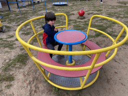 Max on a carousel at the playground at the Garden of the Oertijdmuseum