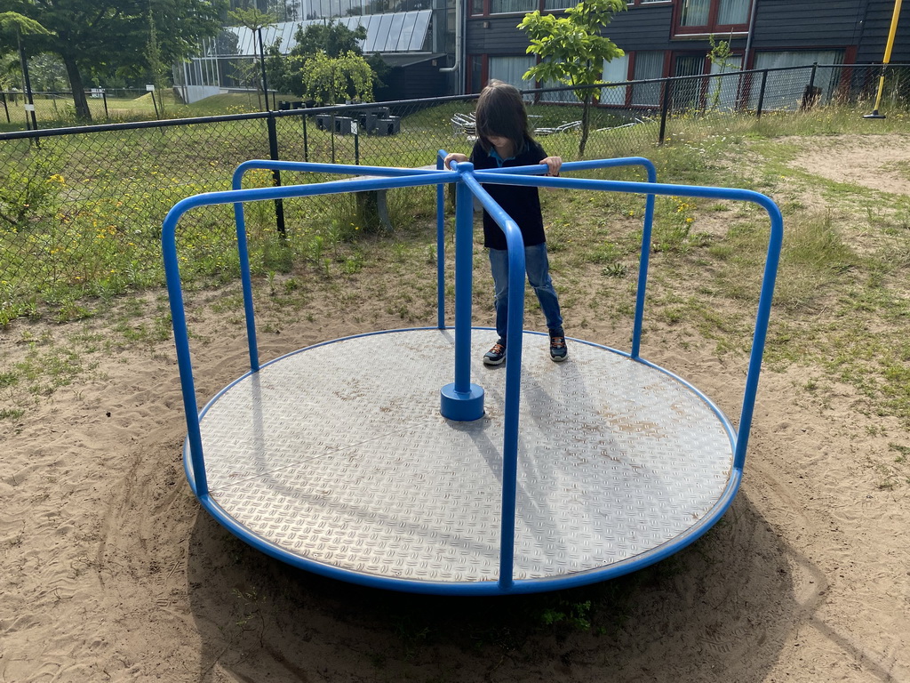 Max on a carousel at the playground in the Garden of the Oertijdmuseum