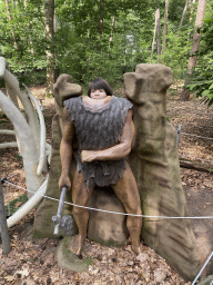 Max with a statue of a caveman in the Oertijdwoud forest of the Oertijdmuseum