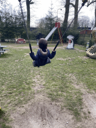 Max on a swing at the playground in the Oertijdwoud forest of the Oertijdmuseum