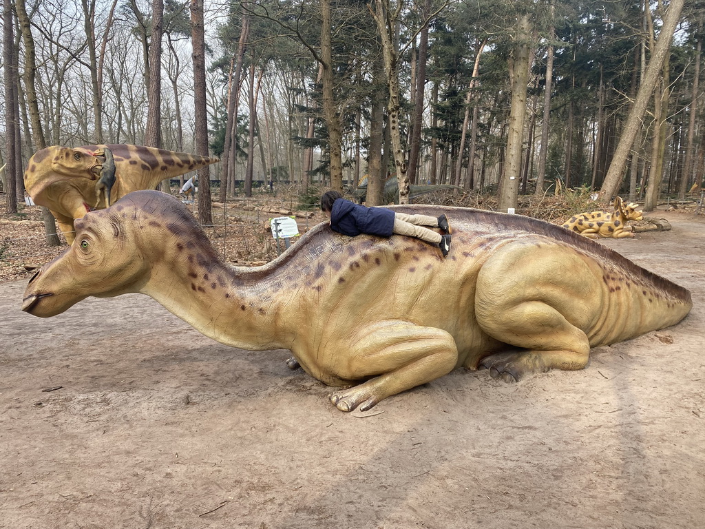 Max climbing on a Maiasaura statue in the Oertijdwoud forest of the Oertijdmuseum