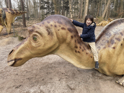 Max on a Maiasaura statue in the Oertijdwoud forest of the Oertijdmuseum