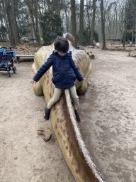 Max on a Maiasaura statue in the Oertijdwoud forest of the Oertijdmuseum