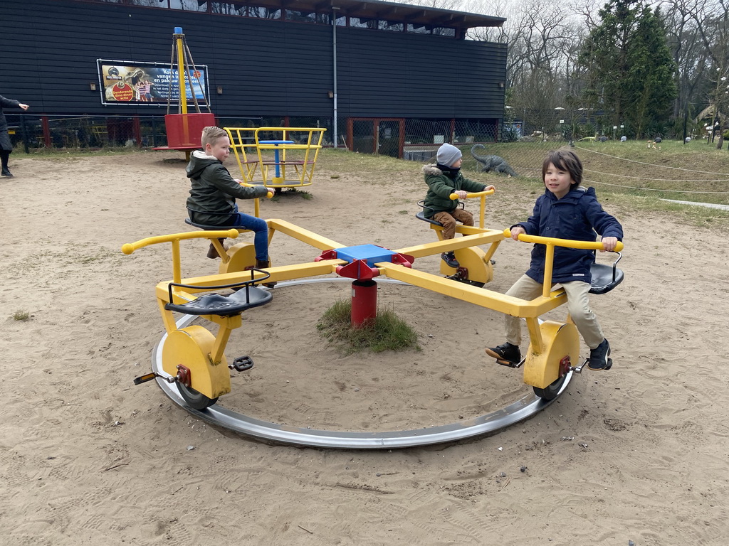 Max on a carousel at the playground at the Garden of the Oertijdmuseum