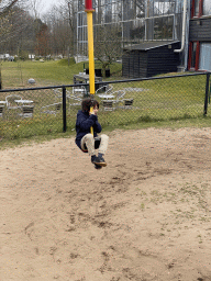 Max on a carousel at the playground at the Garden of the Oertijdmuseum