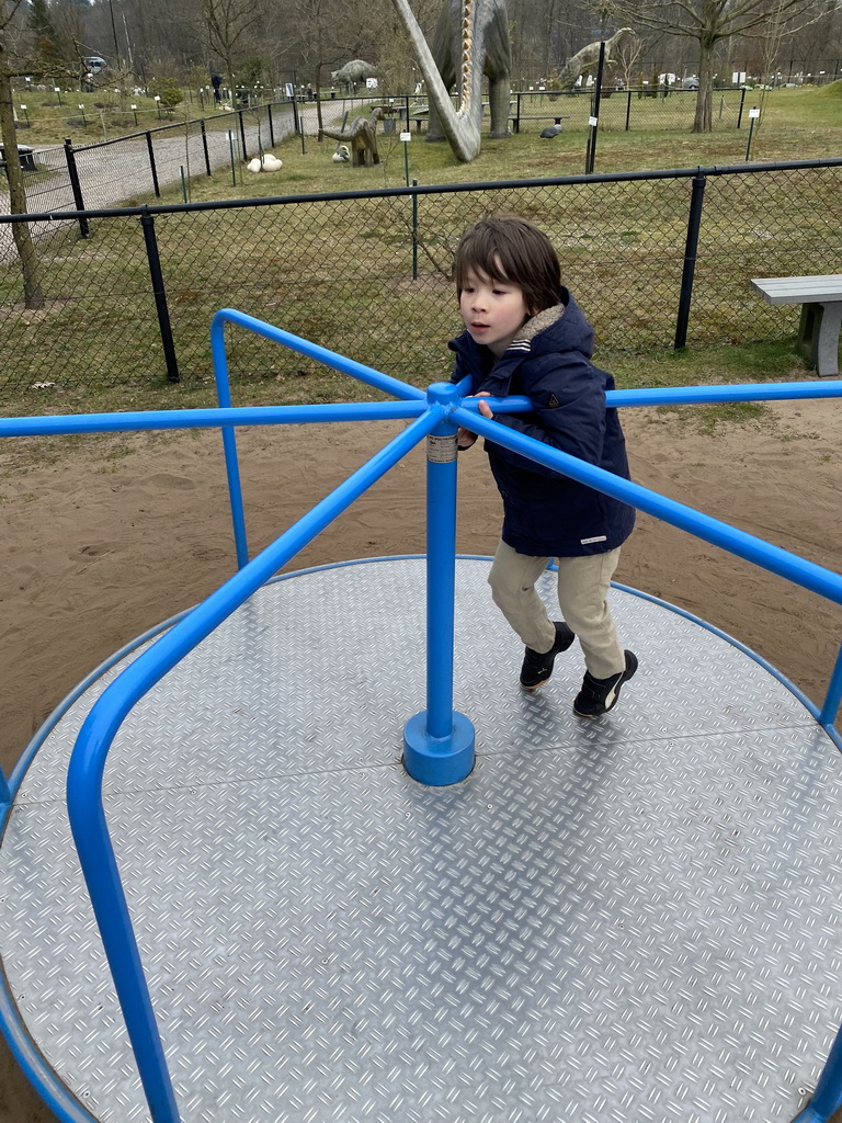 Max on a carousel at the playground at the Garden of the Oertijdmuseum