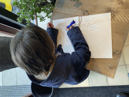 Max writing a message in the guestbook at the Lower Floor at the Museum Building of the Oertijdmuseum