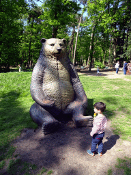 Max with a statue of a Cave Bear at the playground in the Oertijdwoud forest of the Oertijdmuseum