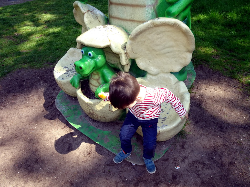 Max on a statue of a Crocodile with eggs at the playground in the Oertijdwoud forest of the Oertijdmuseum